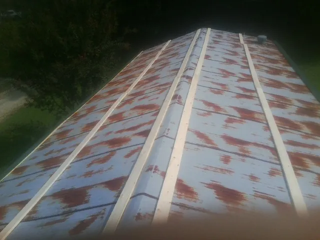 Rusted metal roof panels with new wood purlins before replacement — Storm Damage Roof Repair in Lomax by Roofing Brothers